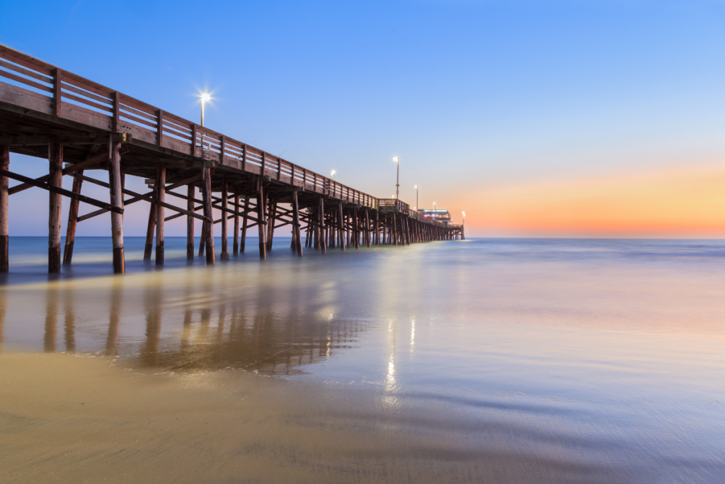 Newport Beach pier over calm water during sunset