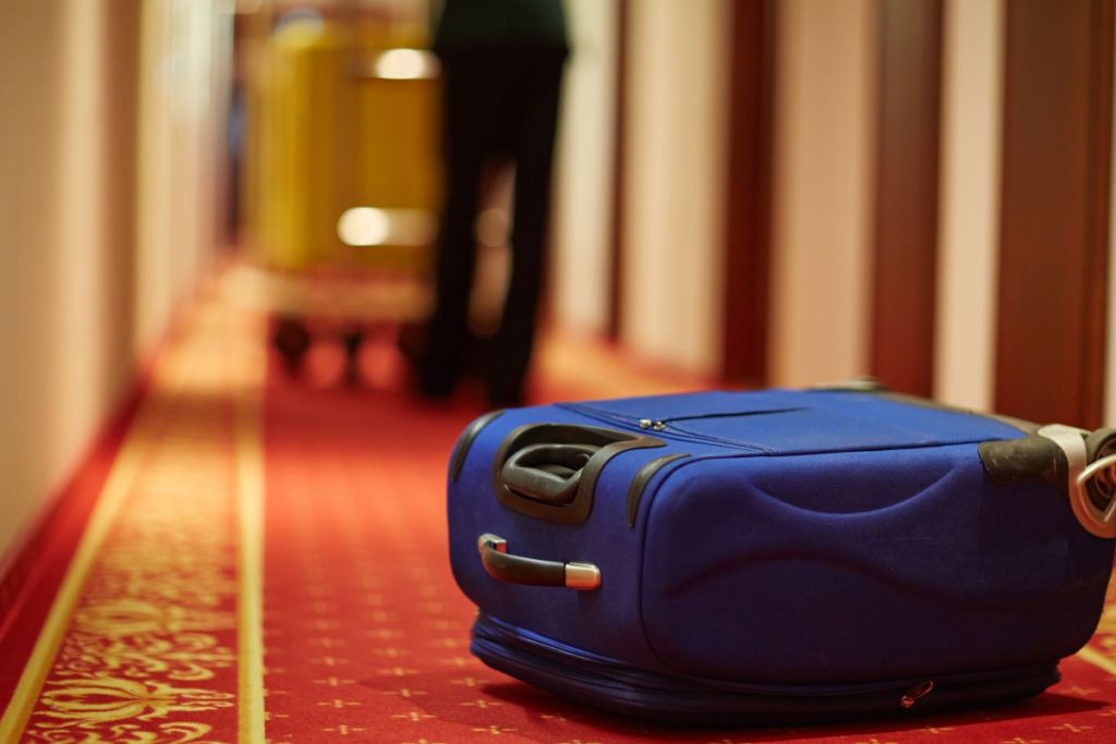 Blue suitcase lying on the floor in a hotel hallway