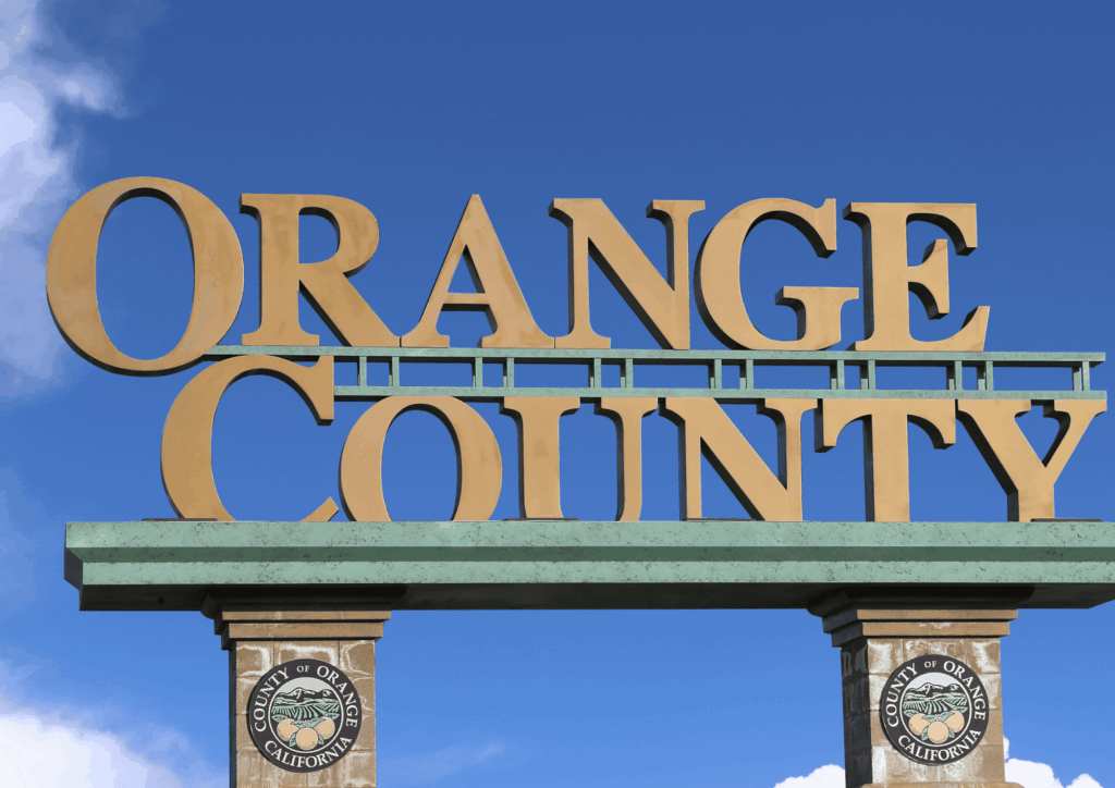 Large Orange County California sign against a bright blue sky