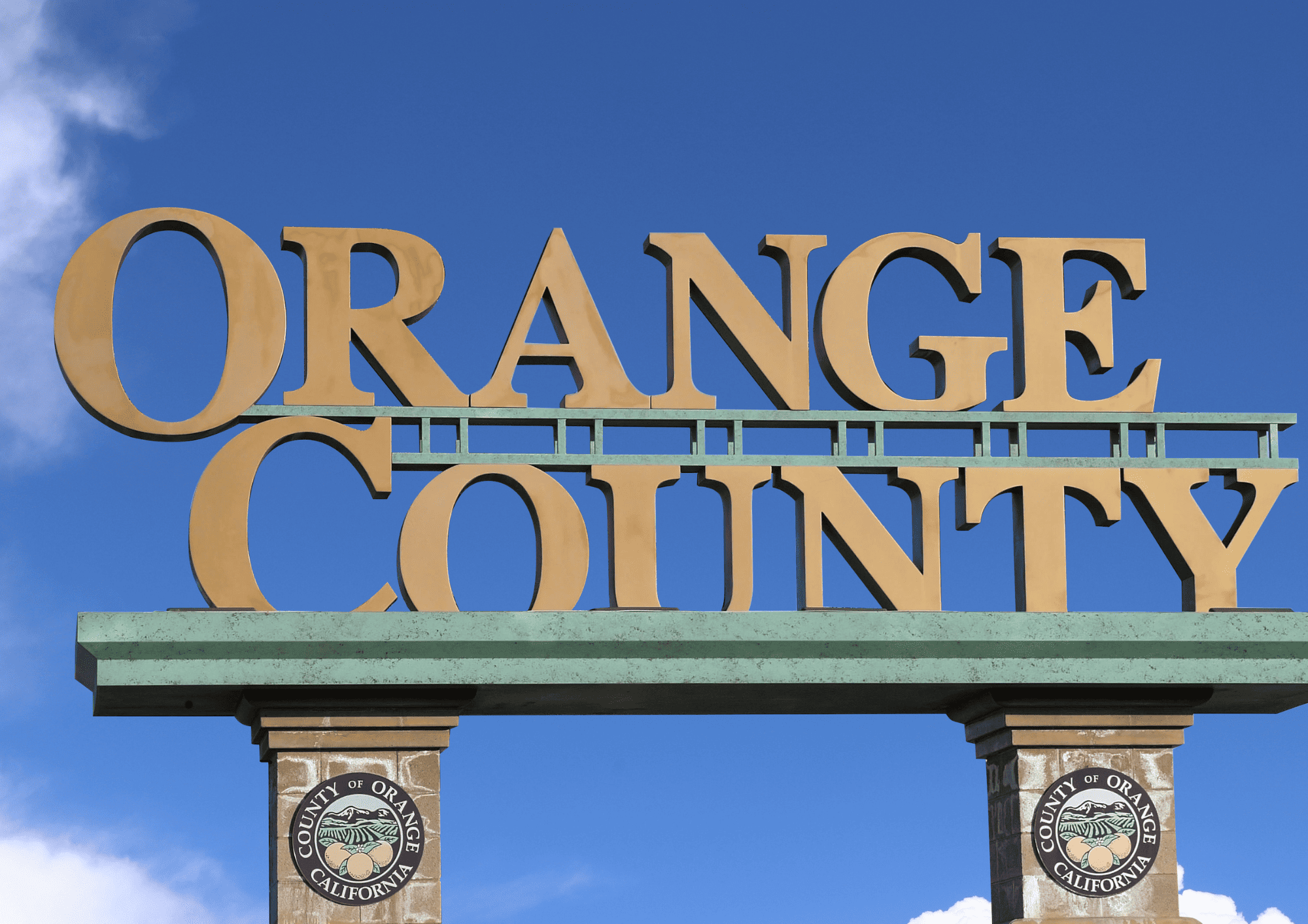 Large Orange County California sign against a bright blue sky